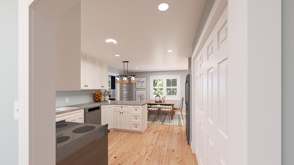 Kitchen and dining area with island, white cabinets, wood floors, and natural light from windows.