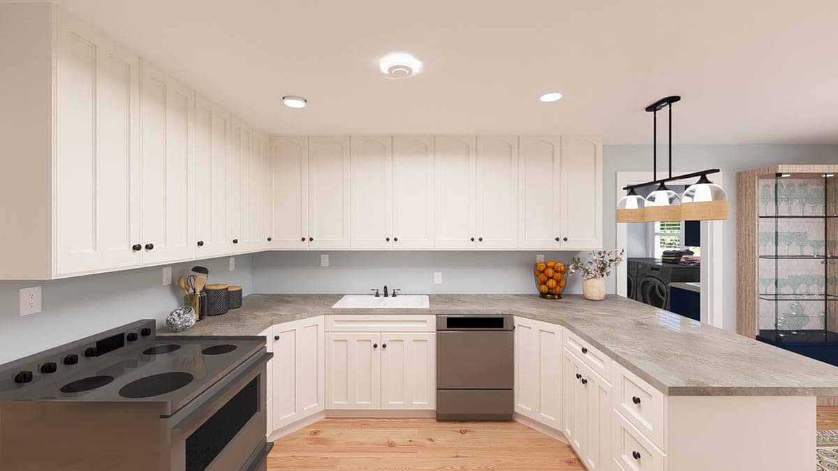 Kitchen interior with white Shaker cabinets, dual basin sink, dishwasher, stove, and adjacent laundry area.