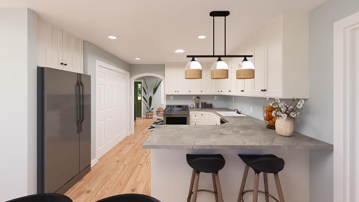 Contemporary kitchen with white cabinetry, gray countertops, stainless steel refrigerator, and pendant lighting.