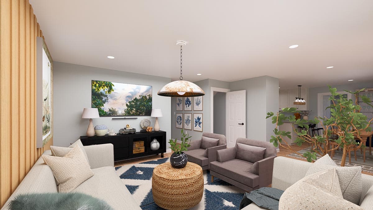 Living room with a sectional sofa, armchairs, woven ottoman, media console, and large TV.