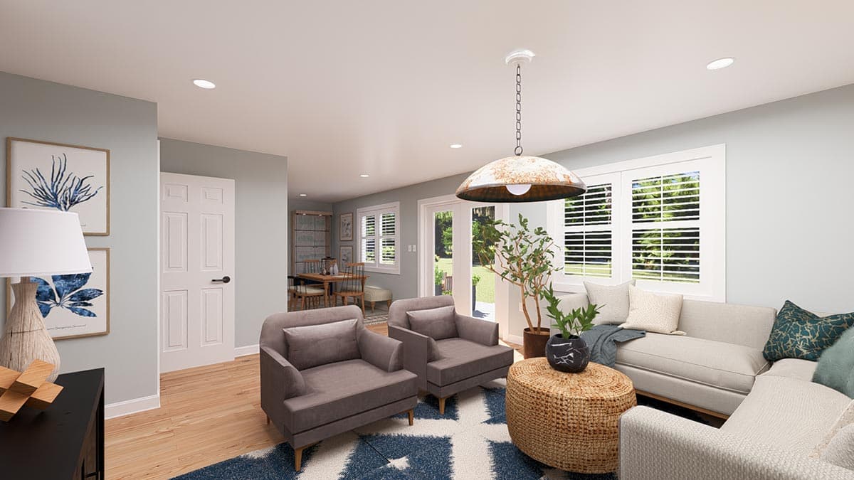 Open concept living area with sectional sofa, chairs, dining nook, and access to backyard.
