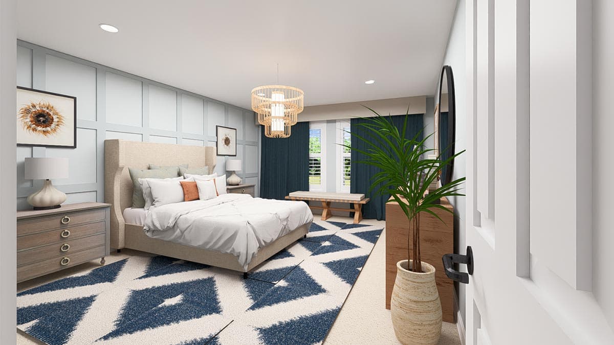 Primary bedroom with upholstered bed, wainscoting, geometric rug, and chandelier.
