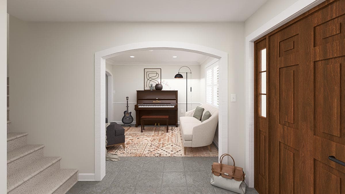 Interior view: Arched entryway to a room with a piano, sofa, guitar, and rug. Wood paneled front door visible.