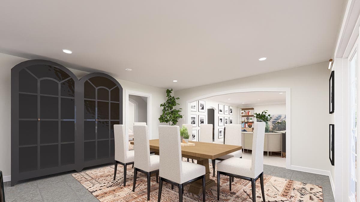 Dining room with arched doorways, a wood table, upholstered chairs, and tall, arched-top cabinets.