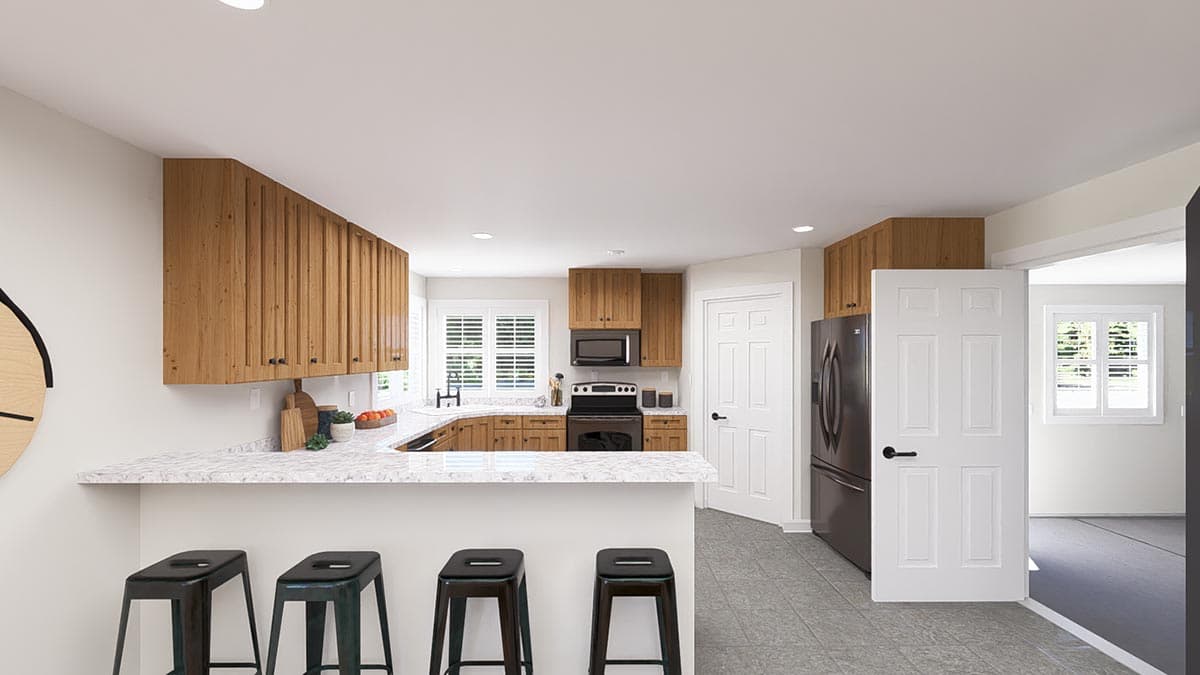 Kitchen with U-shaped counter, wood cabinets, granite countertops, and island seating. Adjacent doorway opens to another room.