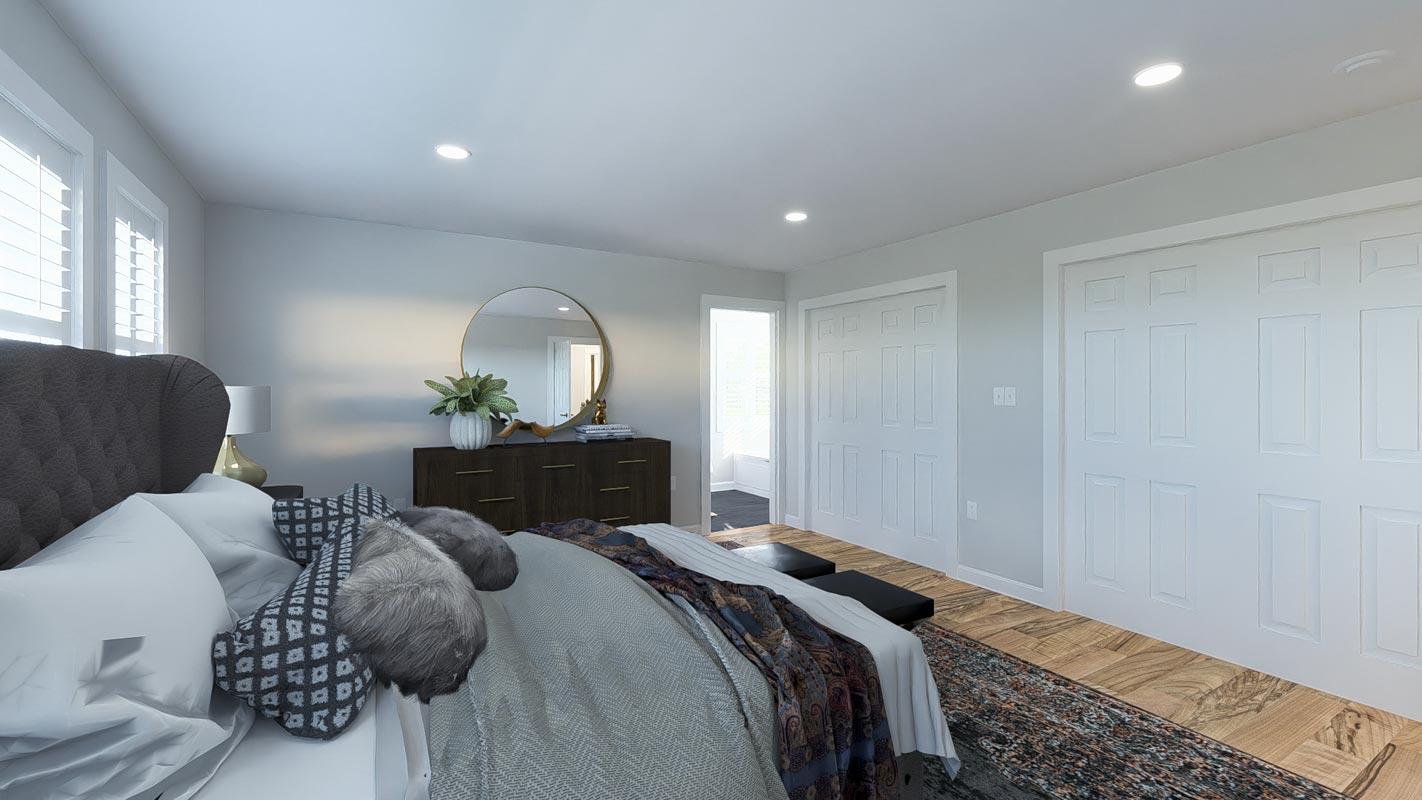 Primary bedroom with tufted headboard, dresser, circular mirror, and double closet doors.