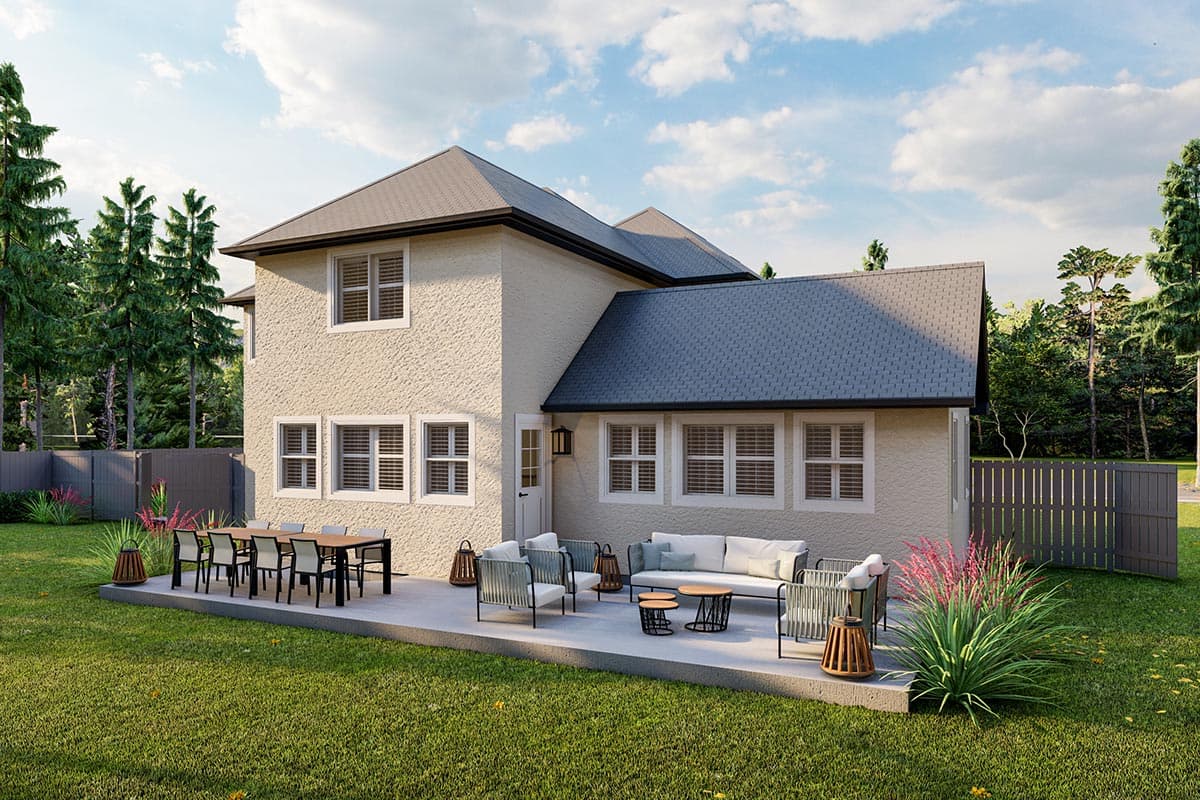 Two-story house plan exterior with stucco finish, multiple gables, and a rear patio with outdoor furniture.