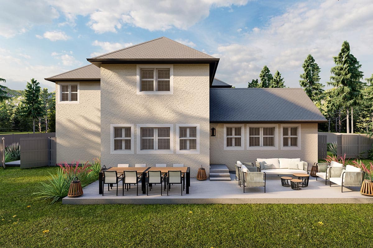 House plan exterior, two stories, stucco finish, multi-level roofline, numerous windows, patio with furniture.