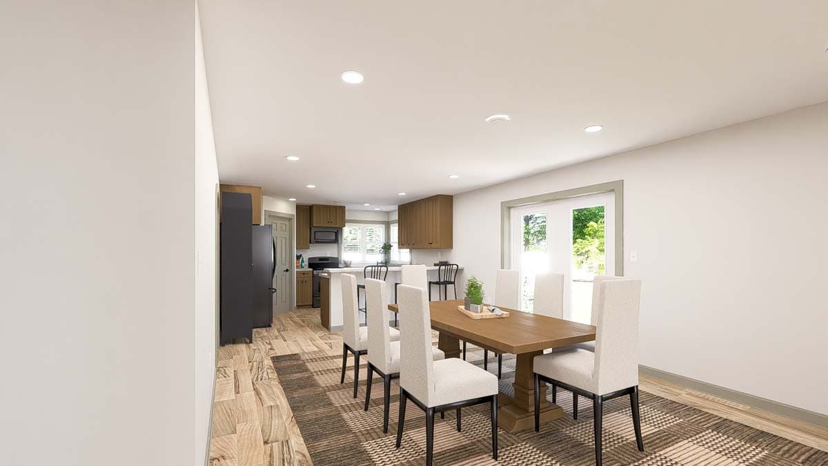 Open concept dining and kitchen area with a dining table, island, and wood cabinetry.