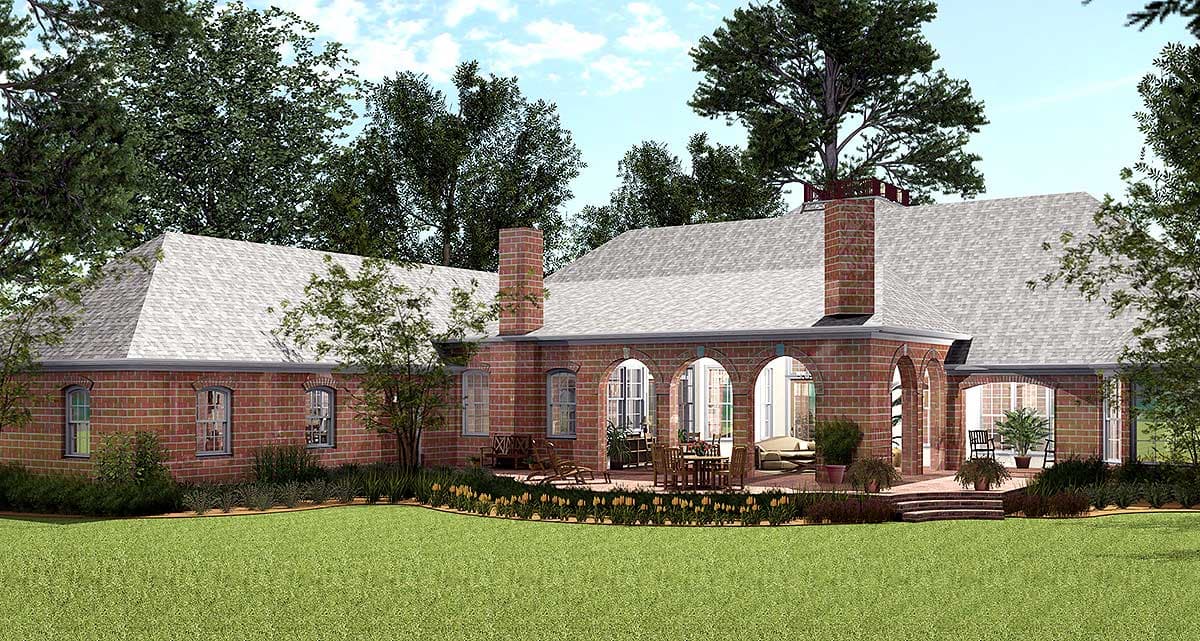 House plan exterior: Red brick ranch with arched covered patio, multiple gables, and prominent chimney.