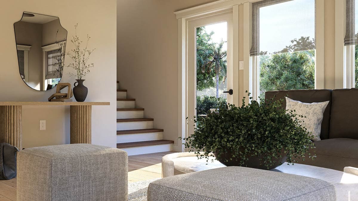Interior rendering shows a living area with a staircase, console table, mirror, ottomans, and sofa with large windows overlooking lush greenery.