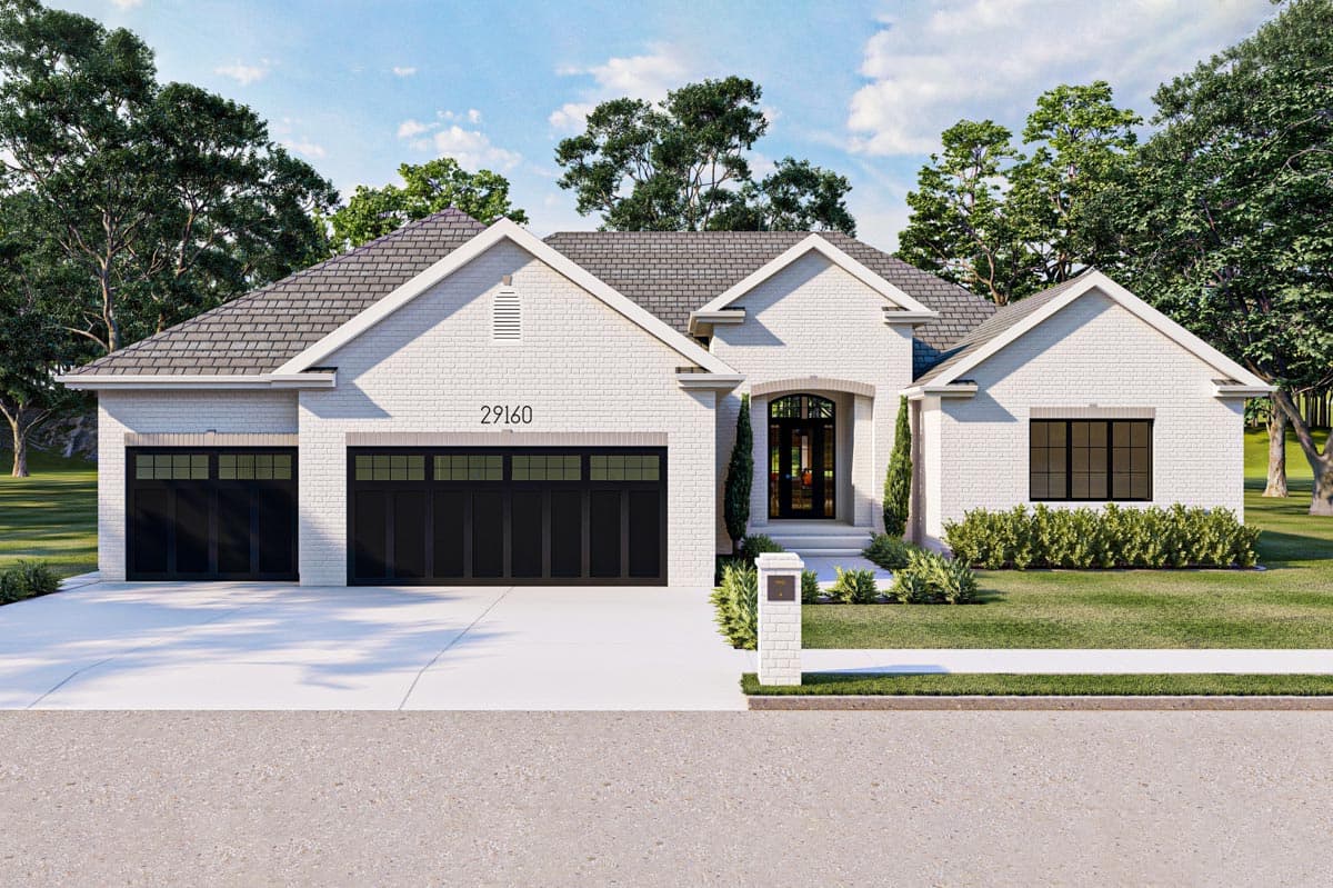 House plan exterior. Ranch style with a two-car garage. Features include gabled roof, brick facade, and arched entry door.