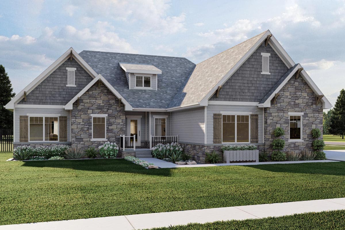 House plan exterior featuring stone and shake siding, multiple gables, dormer, and covered entry.