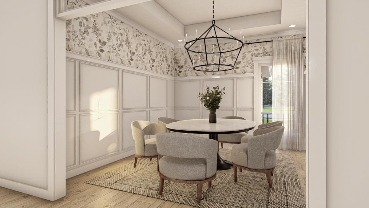 Dining room with round table, upholstered chairs, ornate chandelier, patterned wallpaper, and wainscoting.