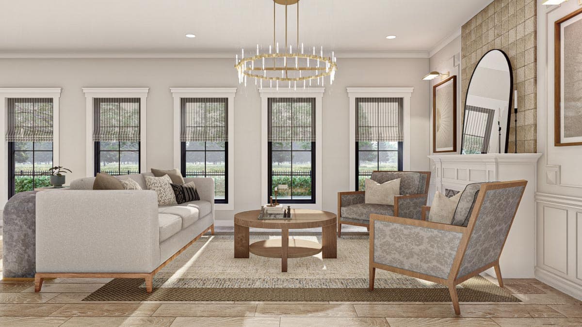 Living room with fireplace, sofa, chairs, round coffee table, and large windows.