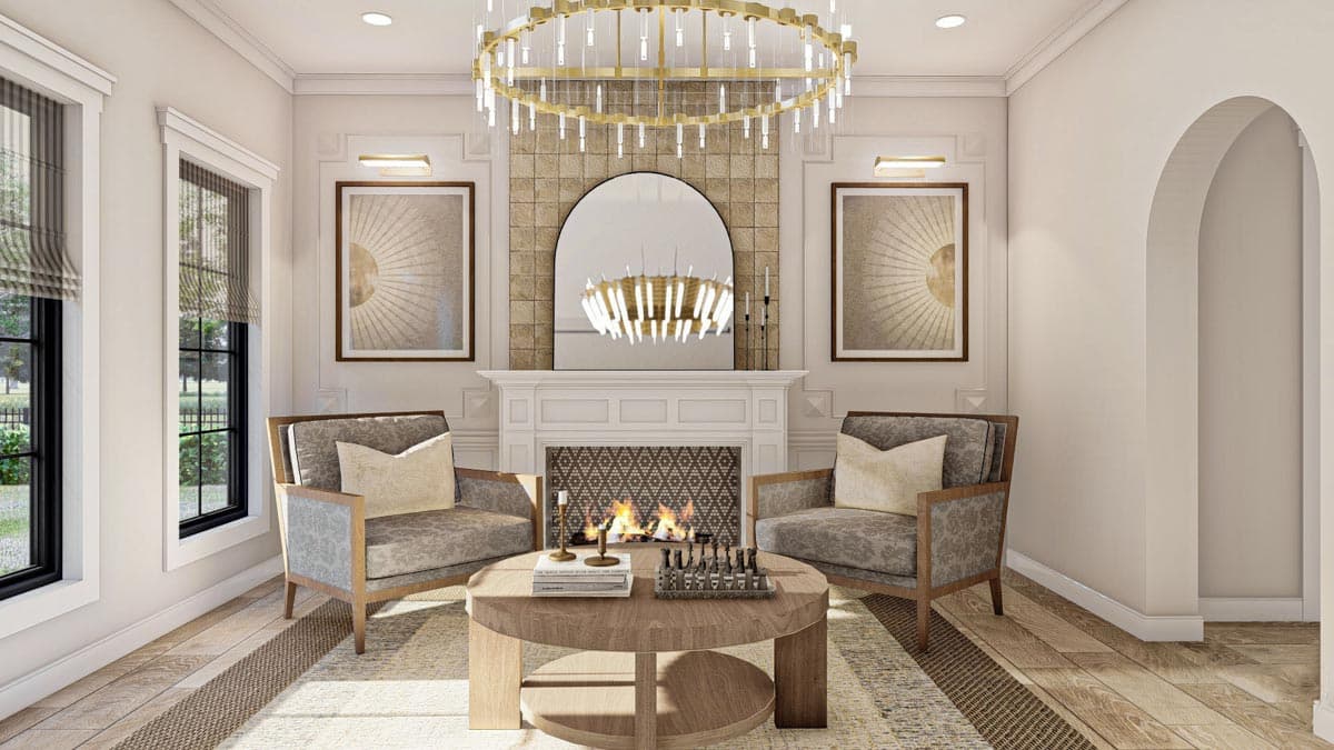 Living room with fireplace, two armchairs, and a round coffee table. Arched doorway to the right.