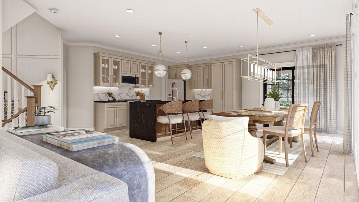 Open concept living area with kitchen island, dining table, and staircase. Includes light wood flooring and neutral palette.