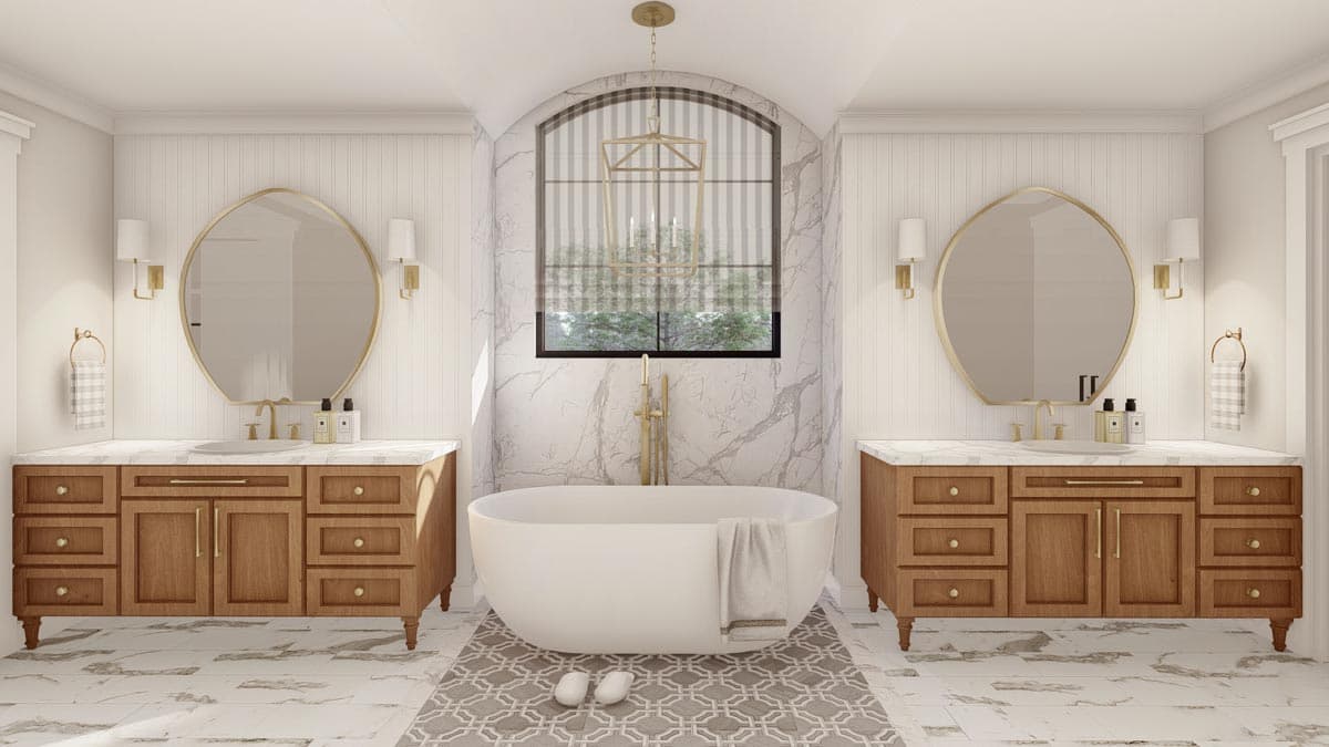 Bathroom with two vanities, freestanding tub, and arched window with gold chandelier.