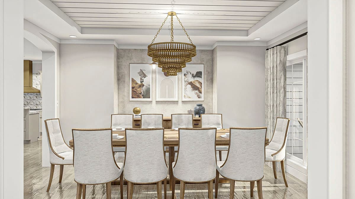 Dining room with seating for ten, ornate chandelier, textured accent wall with artwork, and view into kitchen.