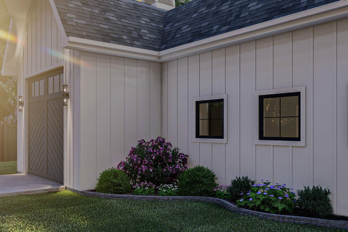 House plan exterior with vertical siding, garage door, and two square windows.