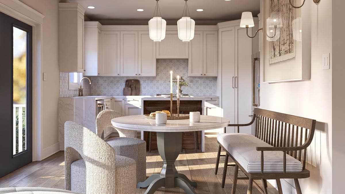 Kitchen and dining area with white cabinetry, marble island, round dining table, and wooden bench seating.