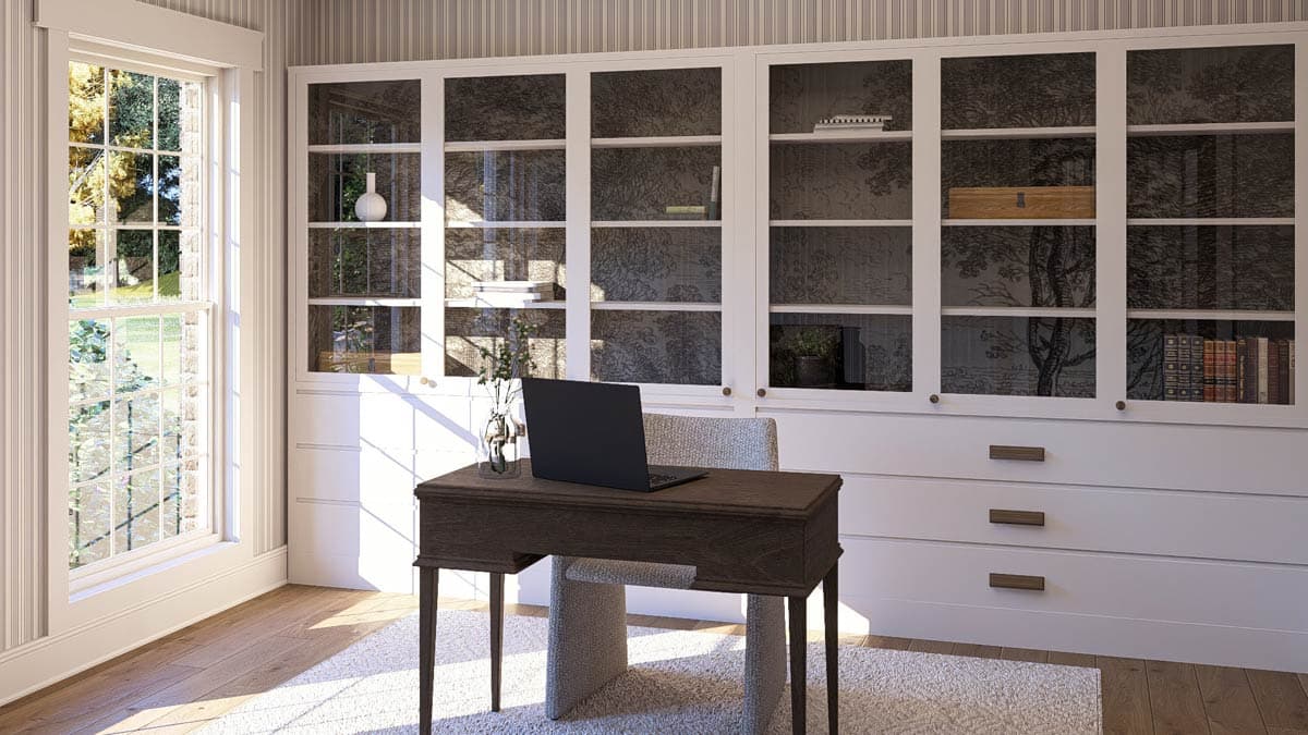 Home office with a desk, chair, and a wall of built-in cabinets with glass doors.