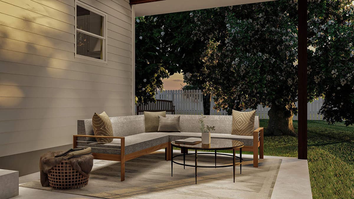 Exterior house plan rendering of a covered patio with sectional sofa, coffee table, and outdoor rug, adjacent to a lawn and trees.