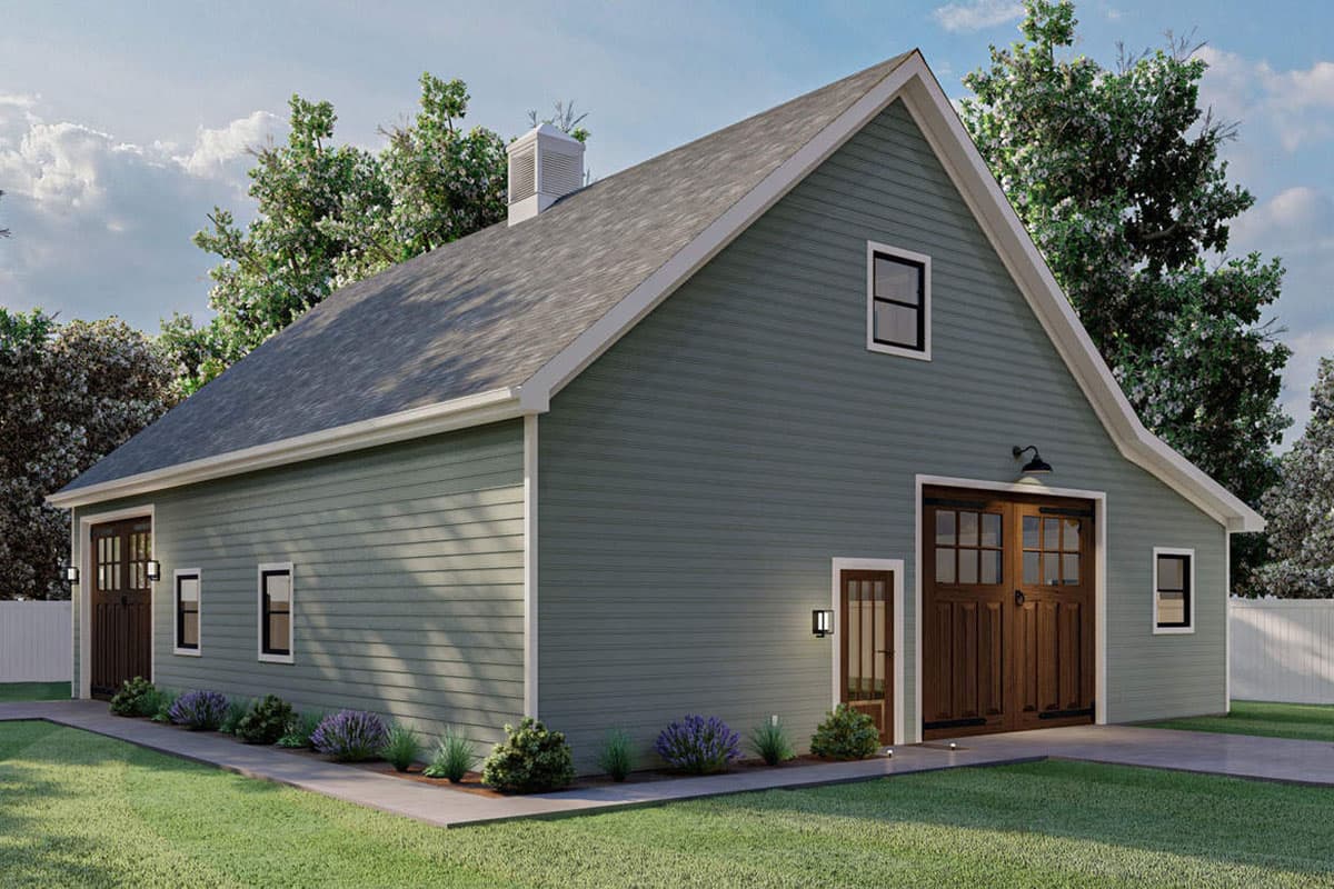 House plan exterior. Two-story barn-style structure with gable roof, carriage-style garage doors, and small window details.