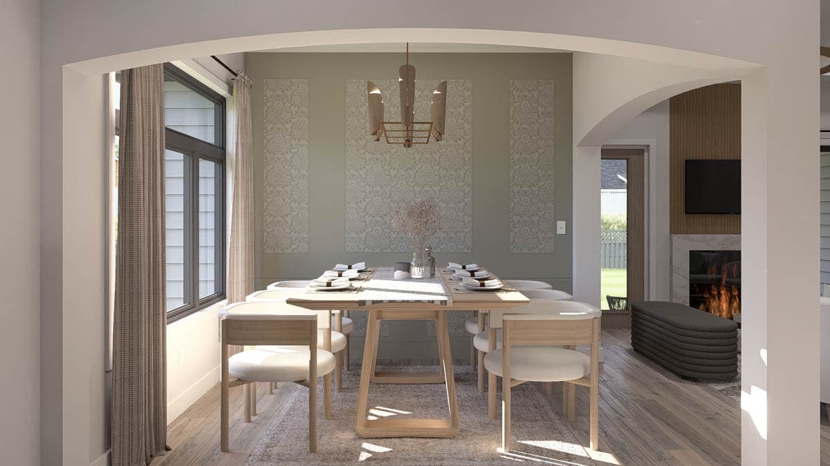 Dining room with table set for six, fireplace and television visible through archway, large window.