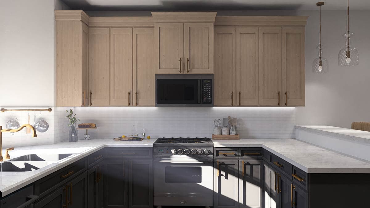 Kitchen interior with two-tone cabinetry, stainless steel range, microwave, and subway tile backsplash.