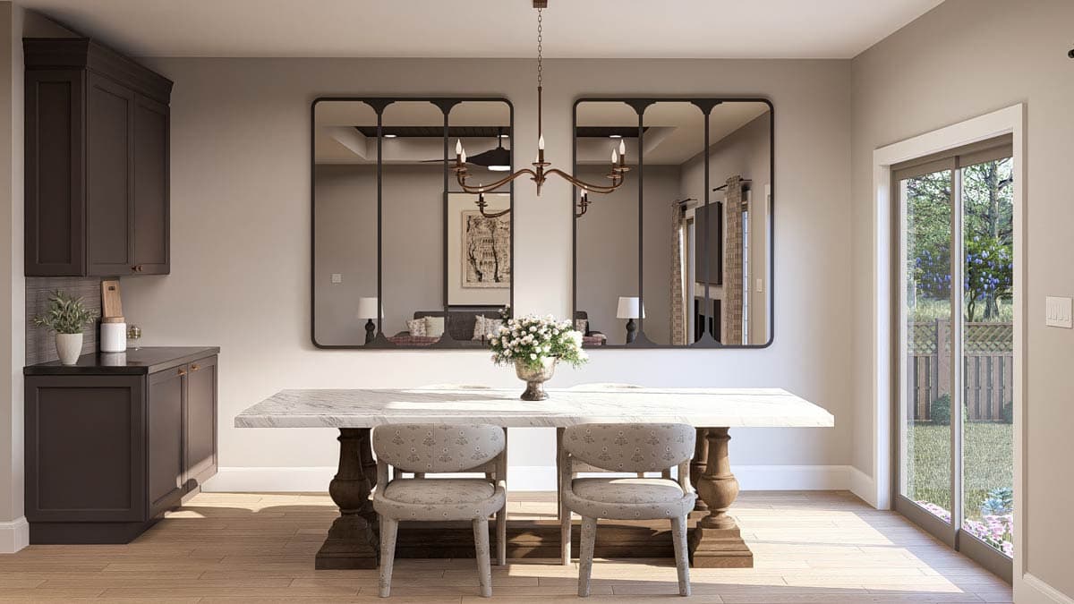 Dining area with marble table, dark cabinetry, and double glass doors opening to a backyard.