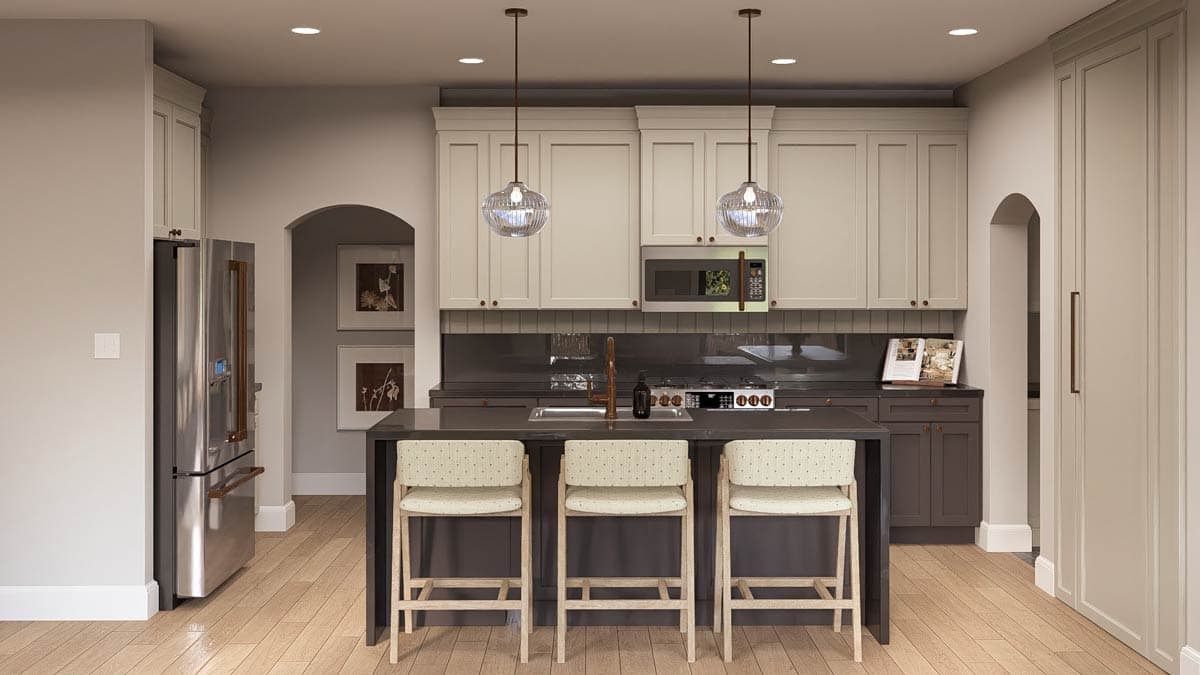Kitchen interior with island, stainless steel appliances, two-tone cabinets, pendant lights, and arched doorway.