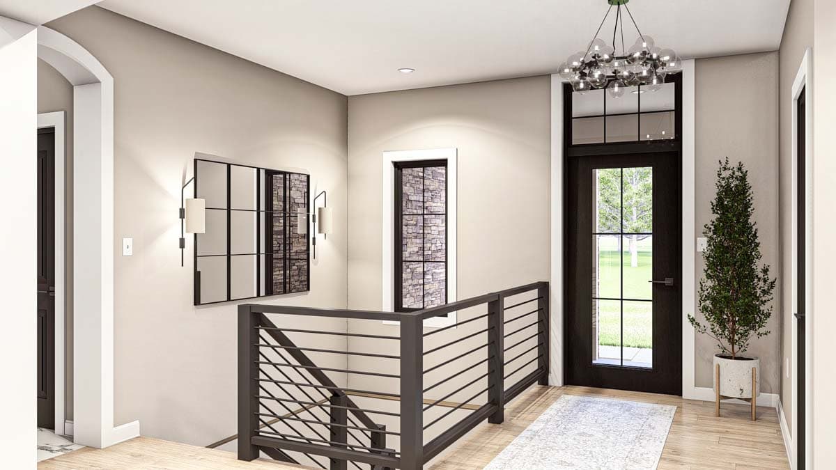 Interior view of a house entryway with a black door, stone accent window, modern railing, and abstract art.