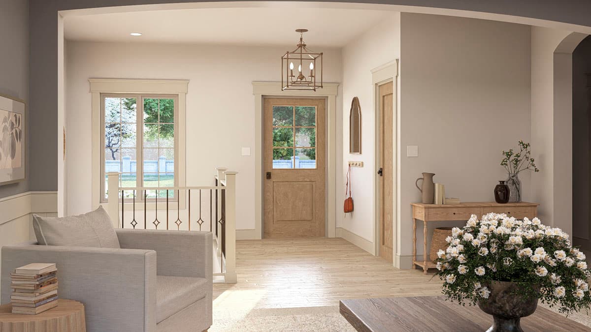 Interior view of entryway with wood door, Palladian window, railing, and decorative lantern.