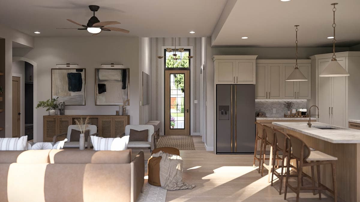 Open concept living area with kitchen island, dining space, and entryway.