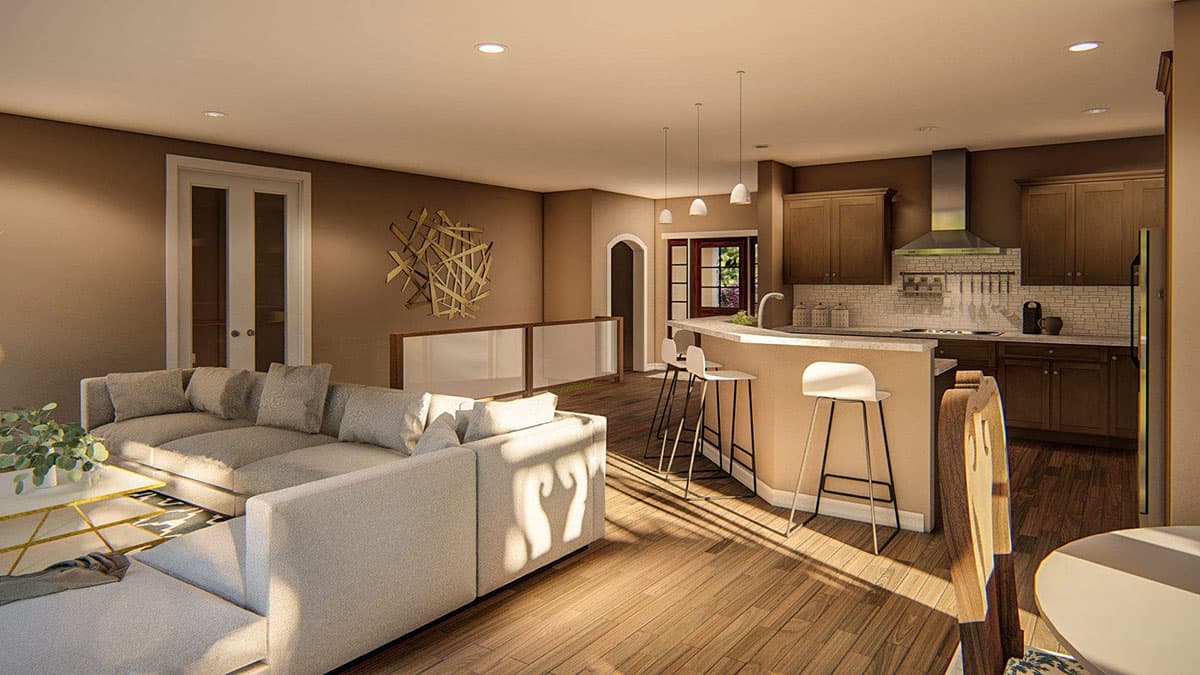 Open concept living area and kitchen with sectional sofa, island bar with stools, and dark wood cabinetry.