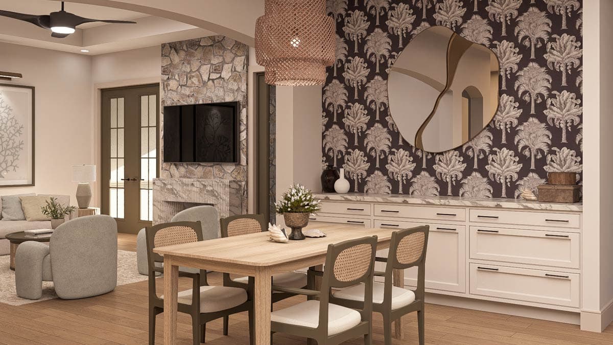 Dining area with wooden table and chairs, stone fireplace with TV, and built-in white cabinetry with marble countertop.