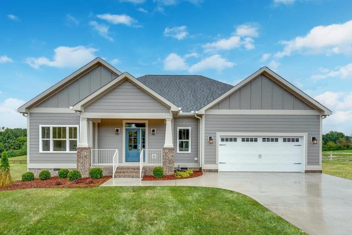One-story house plan exterior with a covered front porch, gable rooflines, siding, and an attached two-car garage.