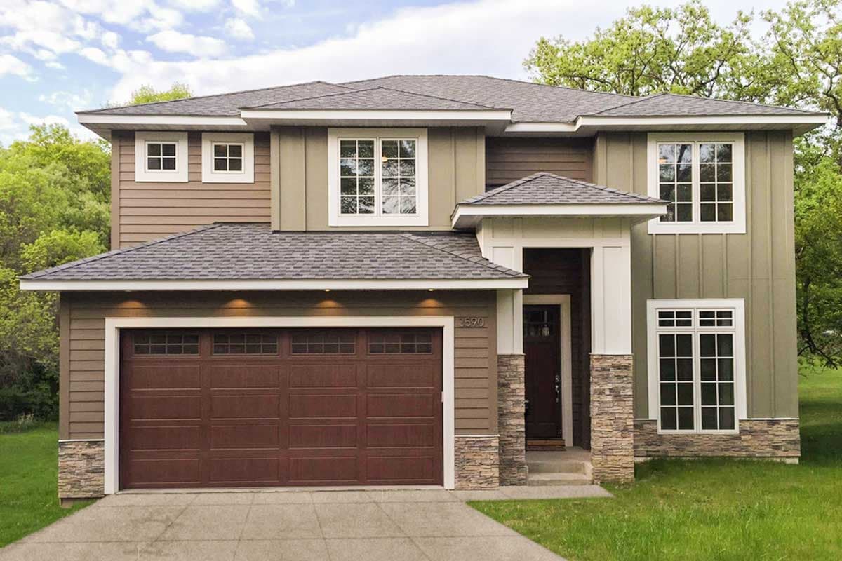 Modern house plan exterior with two stories, a prominent garage, stacked stone accents, and varied siding.