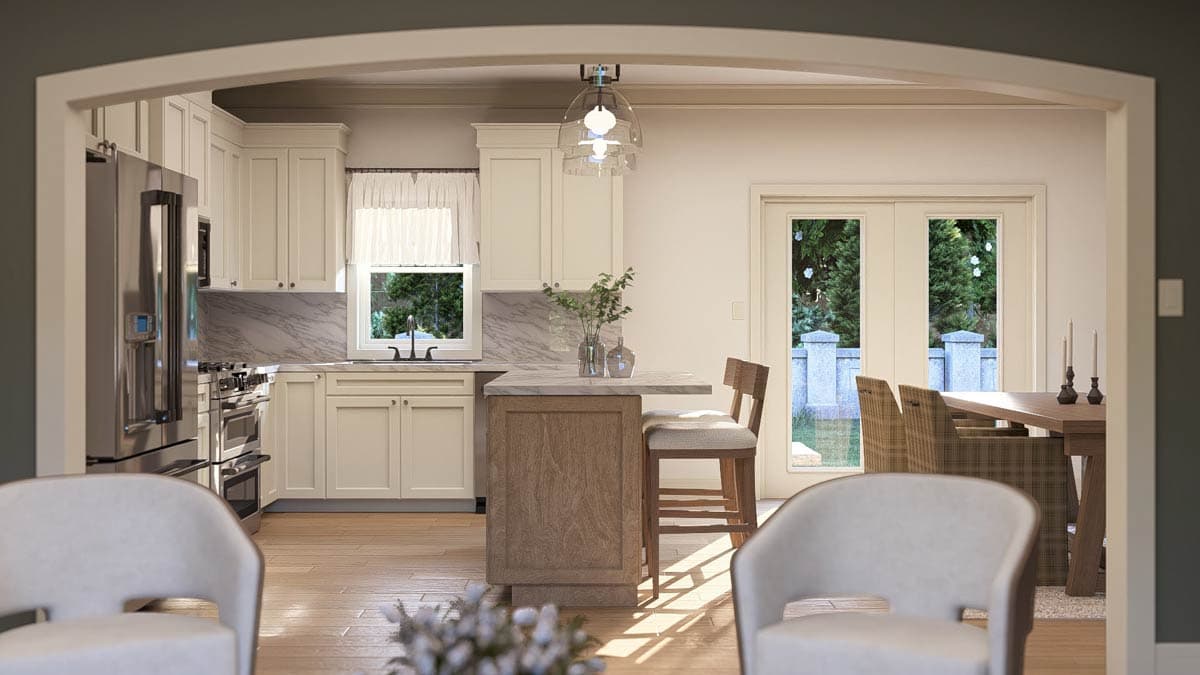 Interior view of a kitchen with light cabinets, marble backsplash, and an island. Dining area with table and chairs visible.