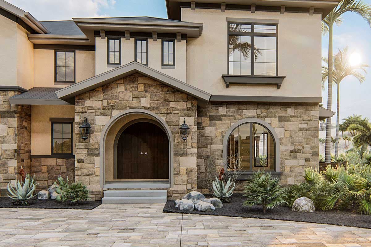 House plan exterior with stone facade, arched entry, and multi-story windows.