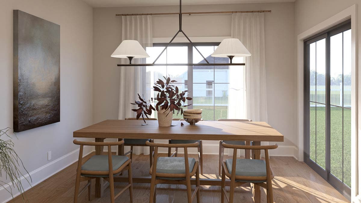 Dining room with wooden table and chairs, large window, artwork, and sliding glass doors.