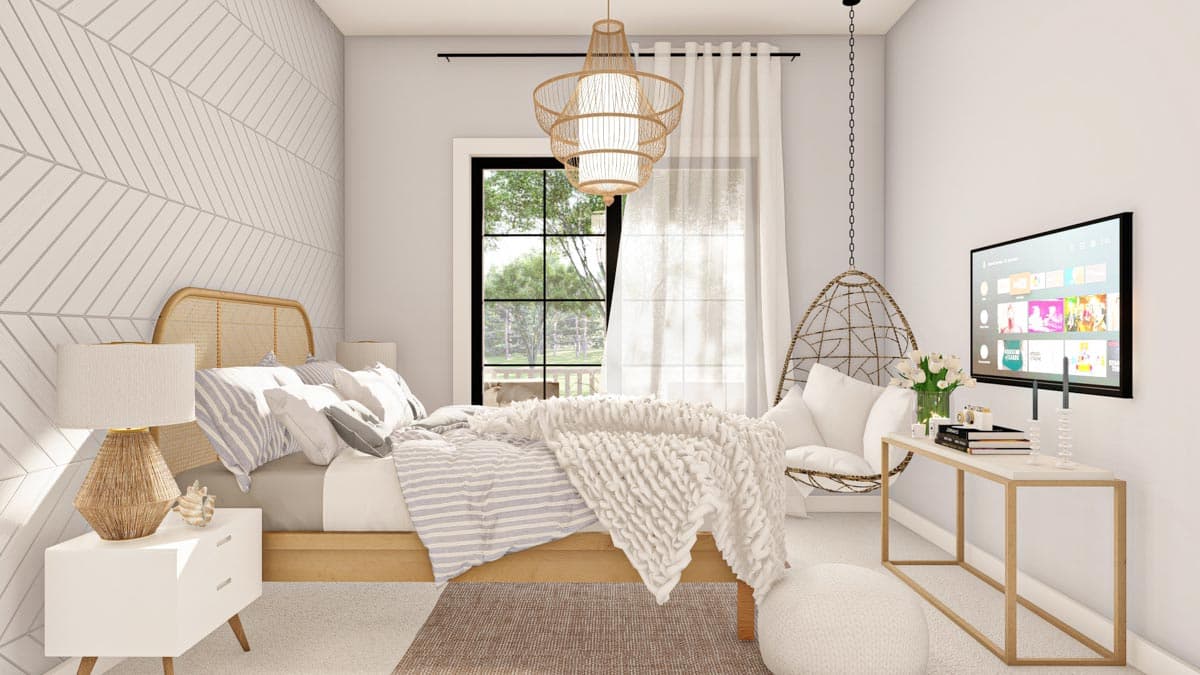 Bedroom interior with a cane headboard bed, geometric wallpaper accent wall, hanging chair, and large window overlooking greenery.