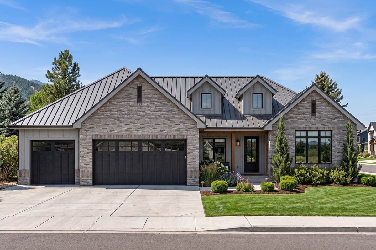 House plan exterior: Modern Farmhouse style, one story, metal roof, stone and siding, two garage doors, dormers.