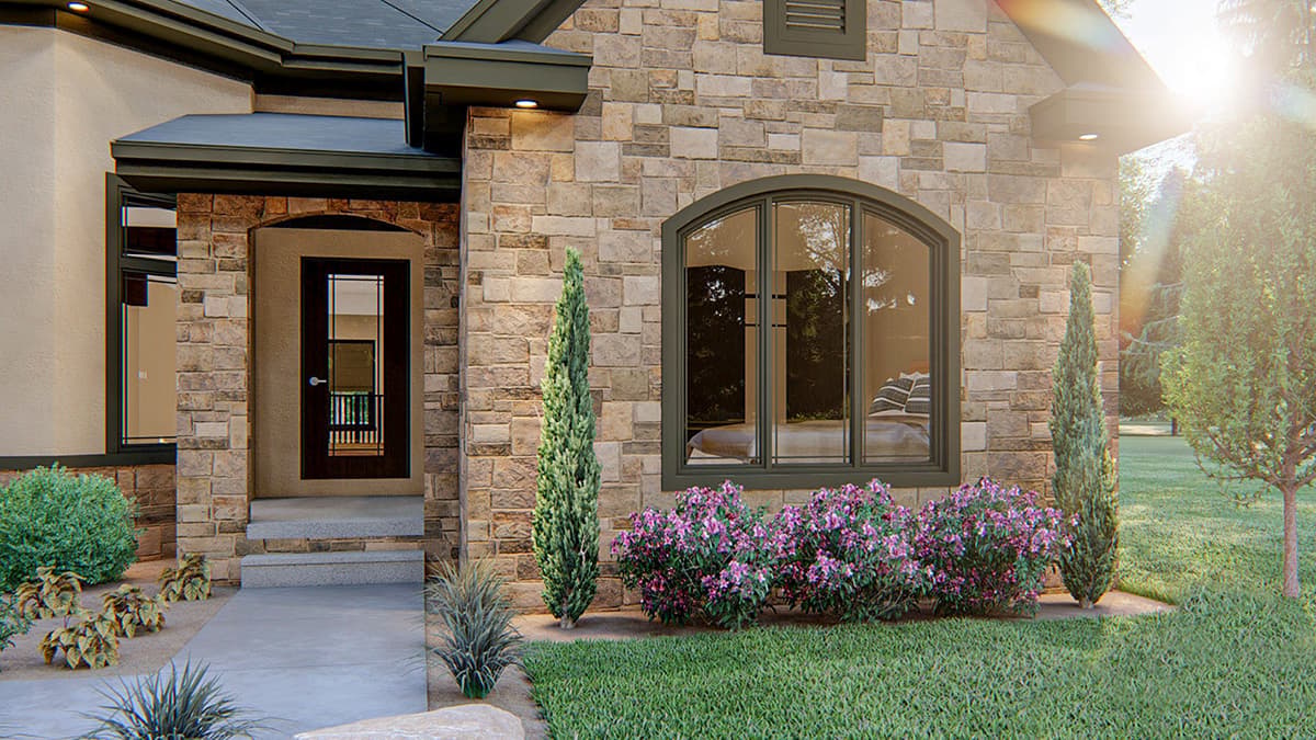 House plan exterior with stone facade, arched entryway, and arched multi-pane window.