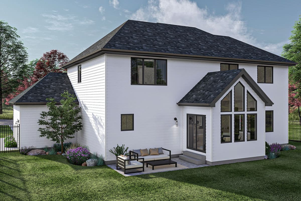 House plan exterior: Two-story home with a detached garage, gabled roof, and a sunroom with a multi-paneled apex window.