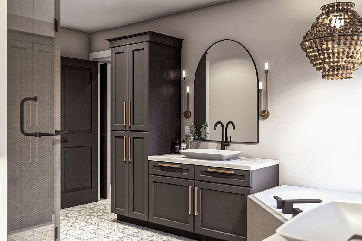 Modern bathroom with dark cabinetry, arched mirror, vessel sink, and walk-in shower.
