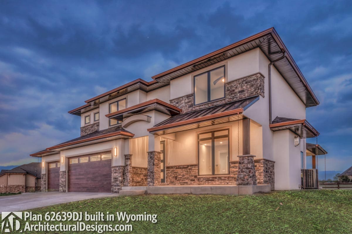 House plan exterior: two-story, modern style with stone accents, multiple gables, and a three-car garage.