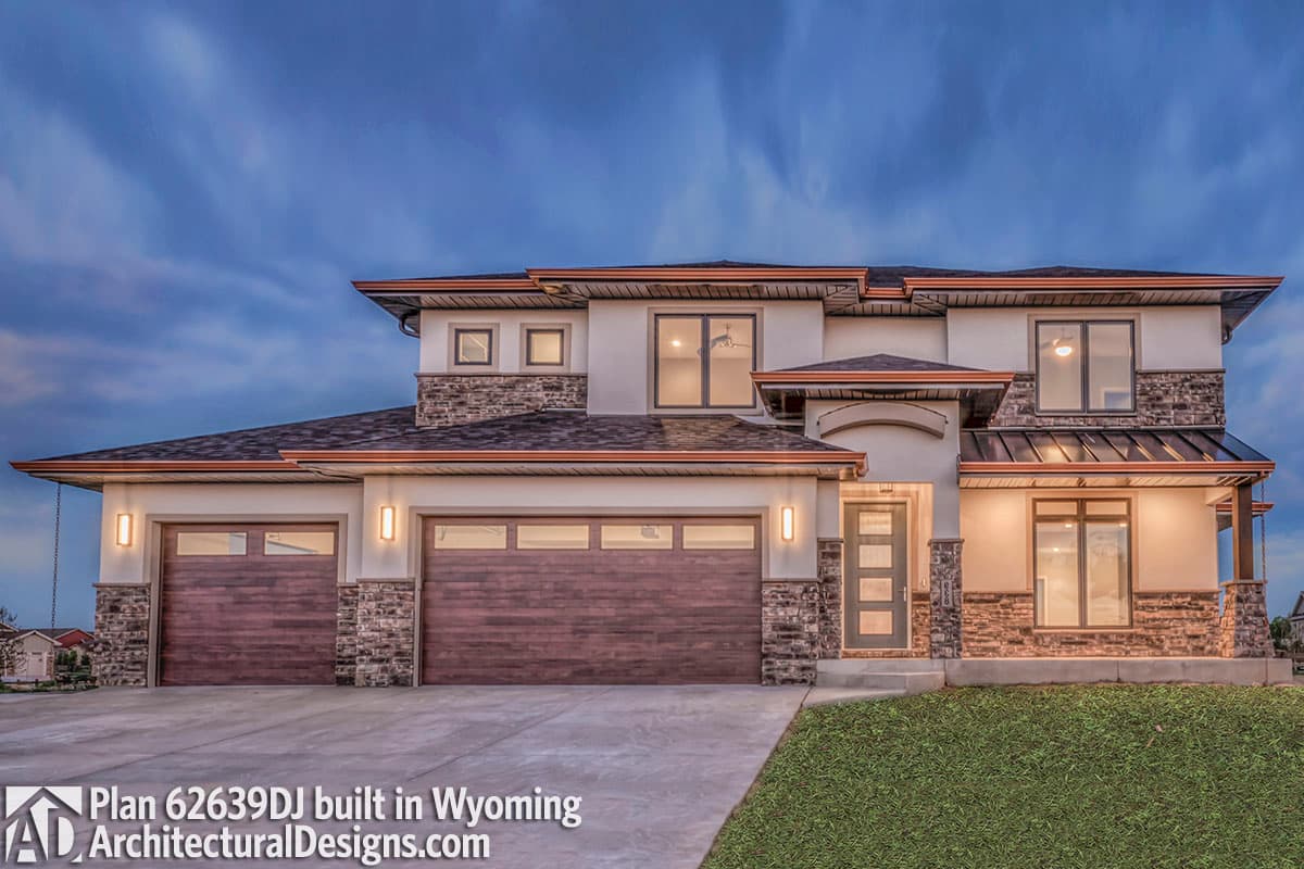 House plan exterior. Two-story modern style with horizontal wood garage doors, stone accents, and flat rooflines with copper gutters.