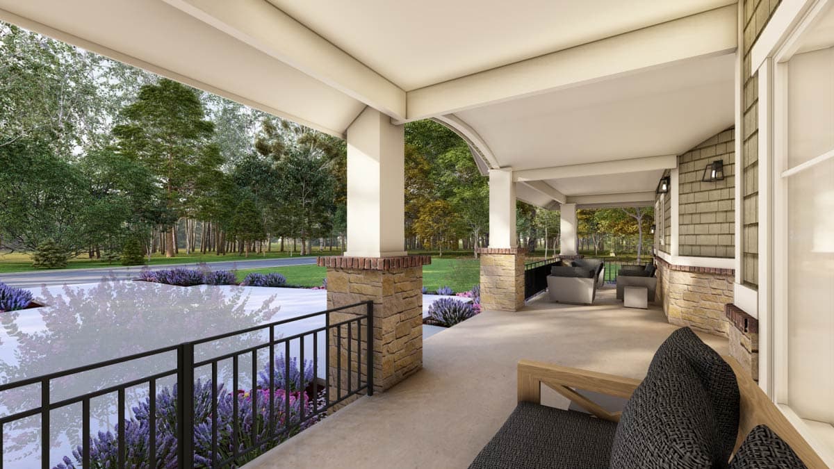 House plan exterior features a wraparound porch with stone and brick-clad columns, shingle siding, and an arched opening.